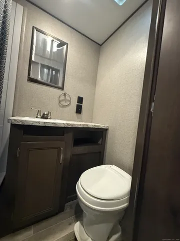 a bathroom with a sink a toilet and mirror