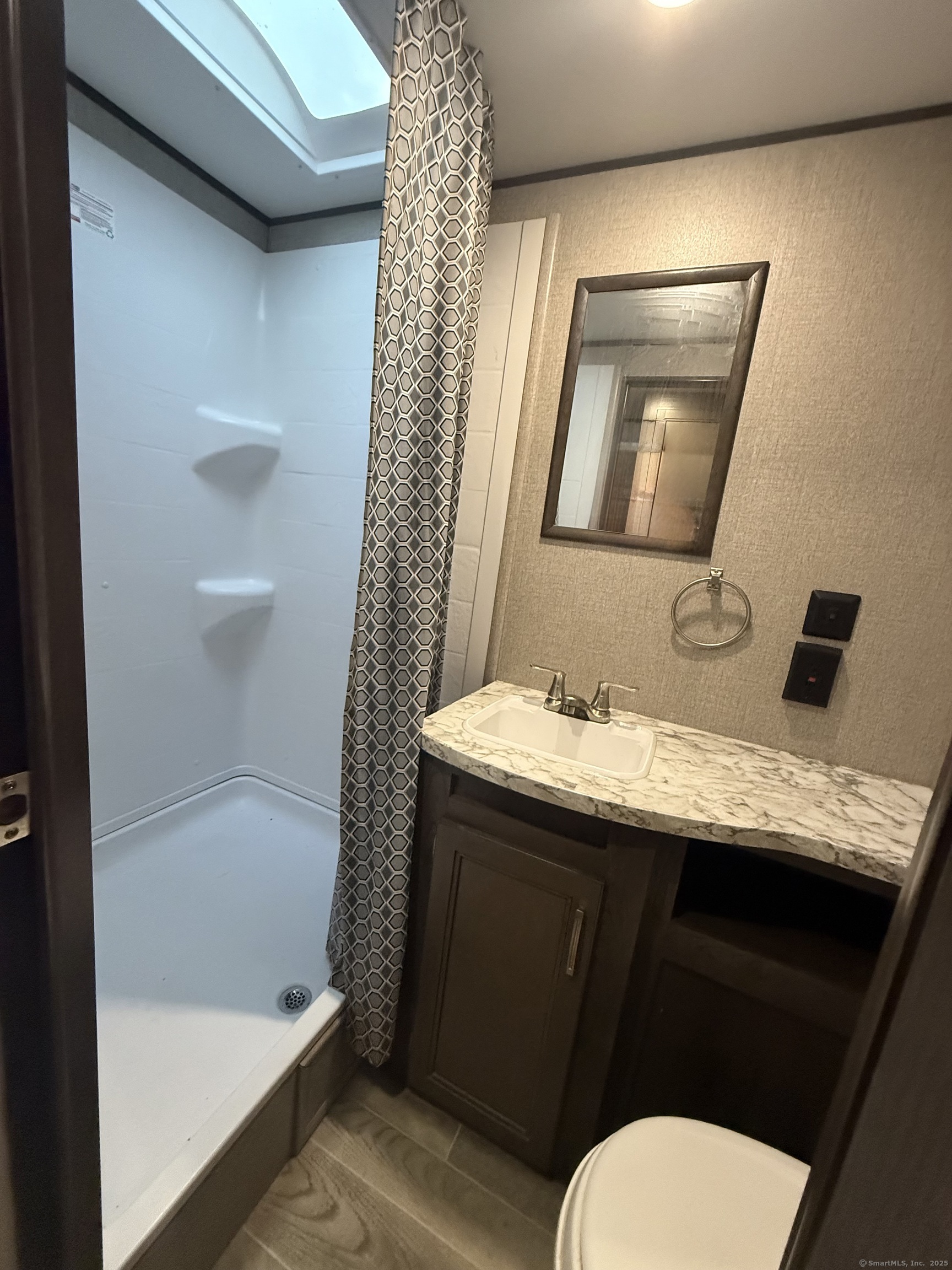 8 S Road, Unit R80 Stafford, CT 06076 - Photo 18 of 36 a bathroom with a granite countertop sink toilet and shower