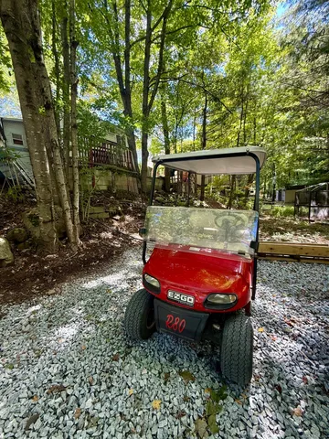 a view of a backyard with table and chairs and a barbeque
