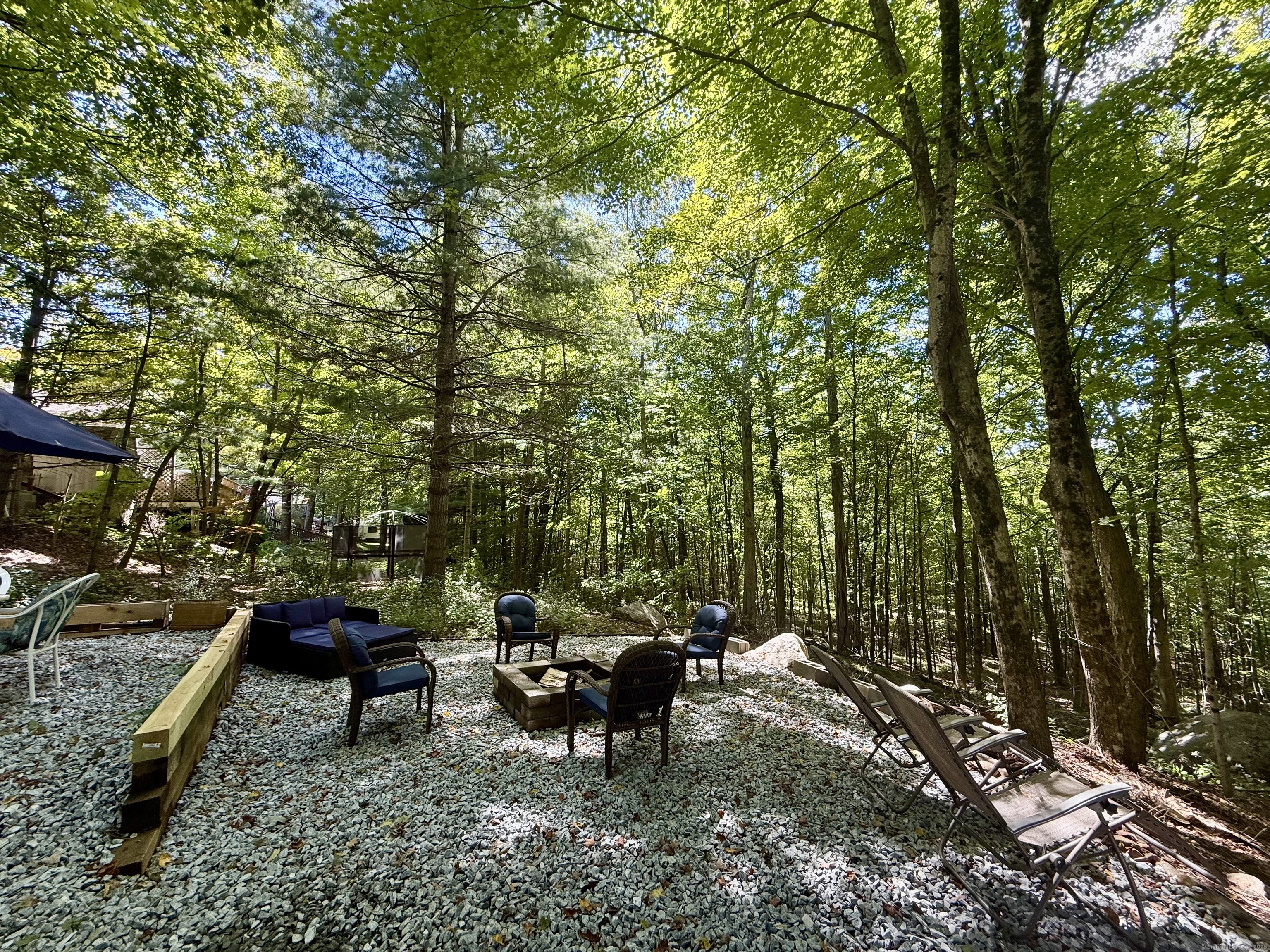 8 S Road, Unit R80 Stafford, CT 06076 - Photo 7 of 36 a view of a bench in a backyard