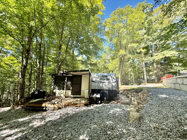 a view of house with backyard and furniture
