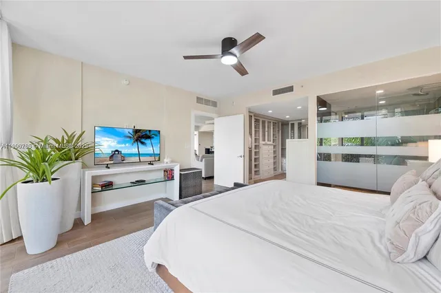 a bedroom with a bed and a potted plant