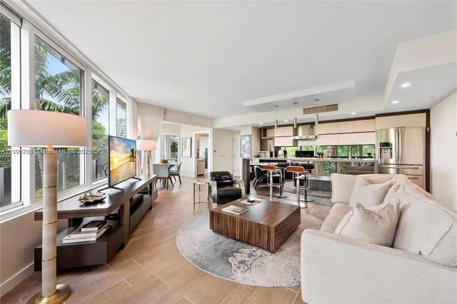 a living room with furniture large window and a table
