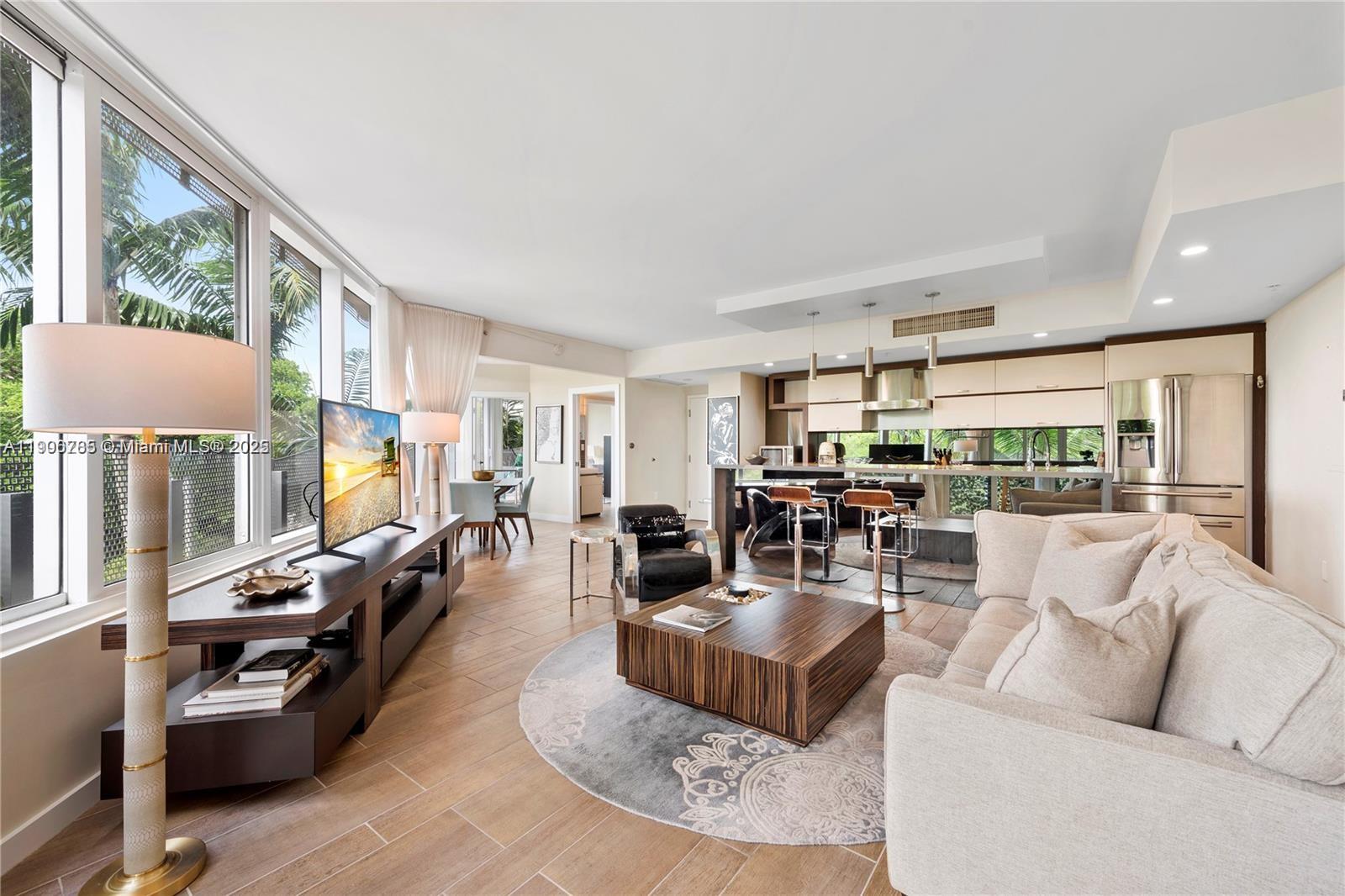 2155 Washington Court, Unit 309 Miami Beach, FL 33139 - Photo 4 of 23 a living room with furniture large window and a table