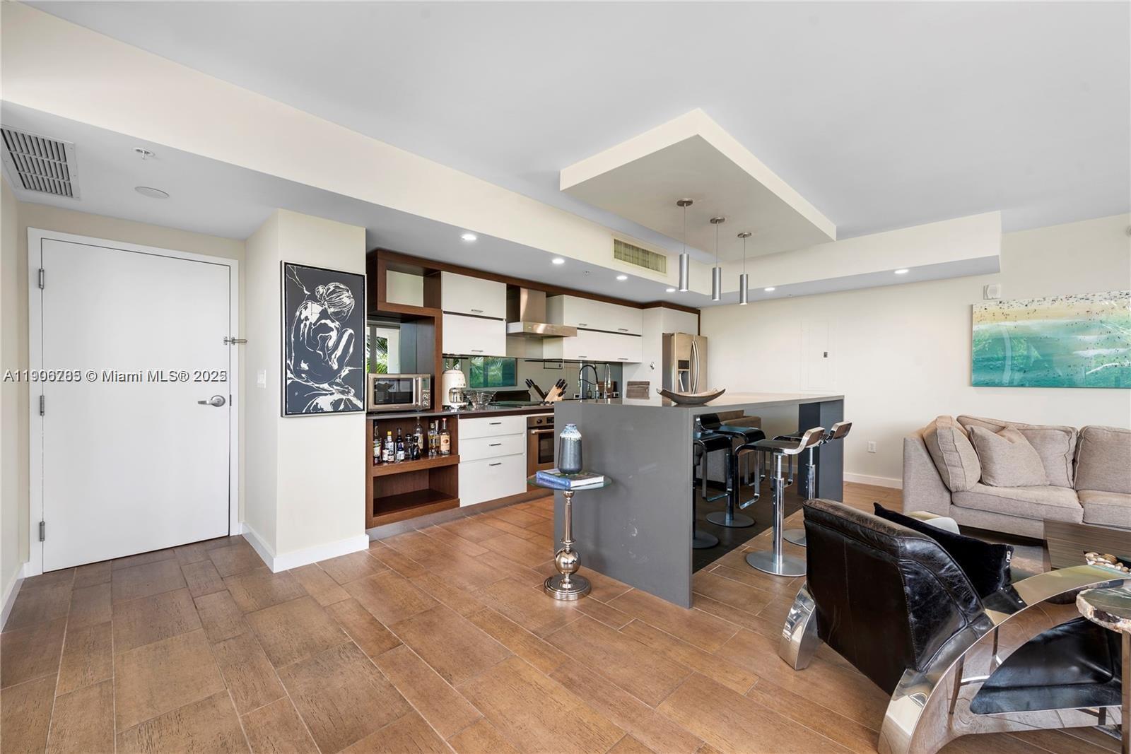 2155 Washington Court, Unit 309 Miami Beach, FL 33139 - Photo 6 of 23 a room with furniture and view of kitchen