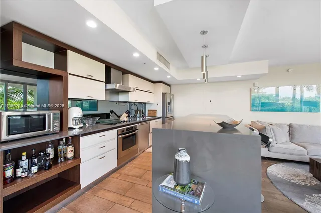 a kitchen with stainless steel appliances granite countertop a sink and stove