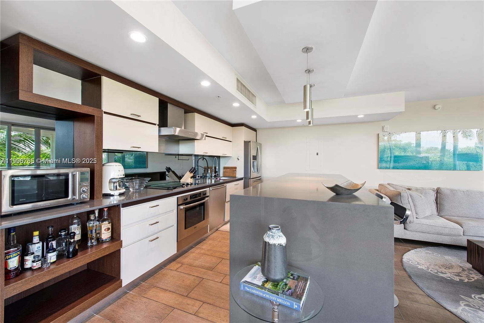 2155 Washington Court, Unit 309 Miami Beach, FL 33139 - Photo 8 of 23 a kitchen with stainless steel appliances granite countertop a sink and stove