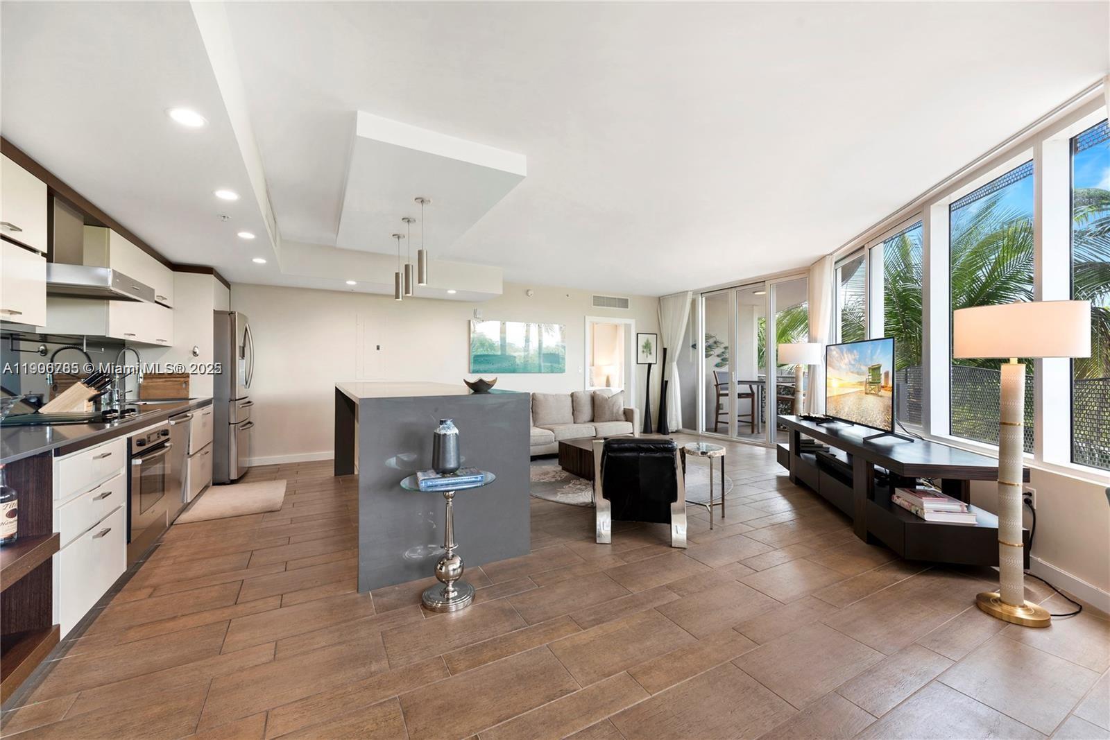 2155 Washington Court, Unit 309 Miami Beach, FL 33139 - Photo 9 of 23 a living room with patio furniture and a large window