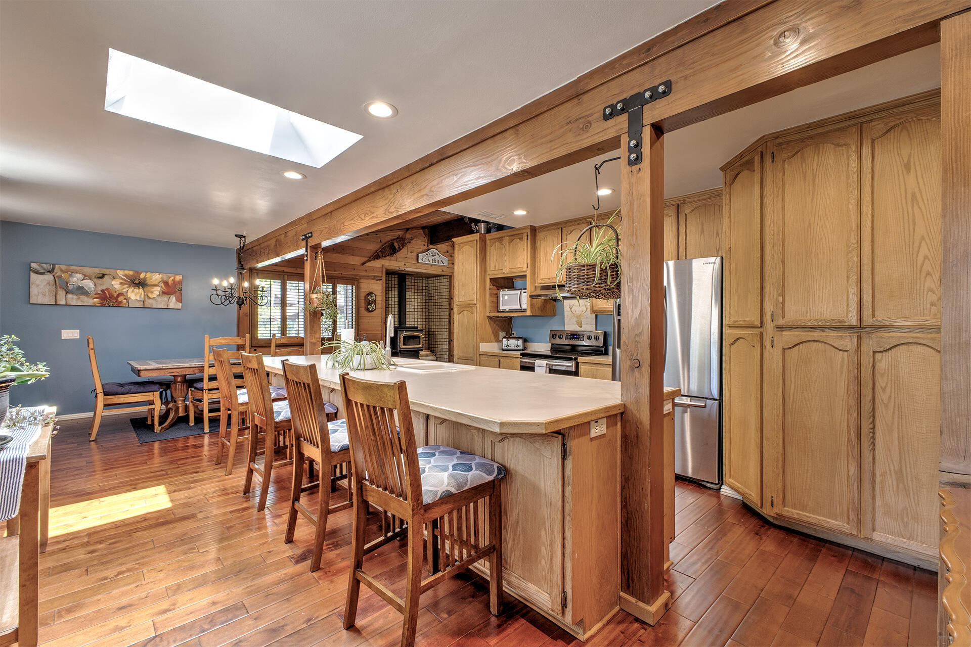 53394 Tollgate Road Idyllwild, CA 92549 - Photo 29 of 53 a kitchen with stainless steel appliances a table chairs refrigerator and cabinets