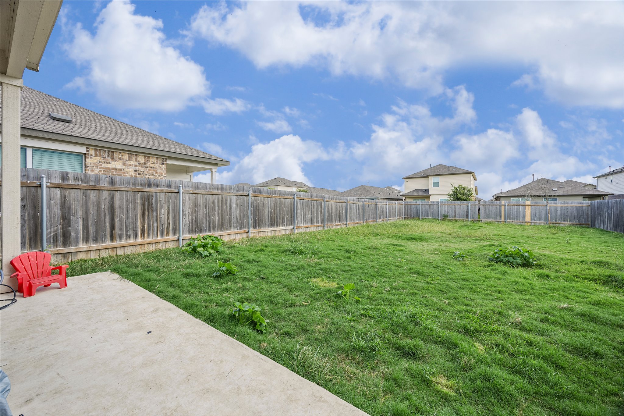 217 Canley Loop Hutto, TX 78634 - Photo 31 of 36 A spacious, fully fenced yard awaits, offering ample room for outdoor activities and relaxation.