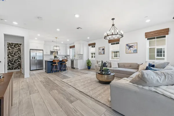 a living room with furniture and kitchen view