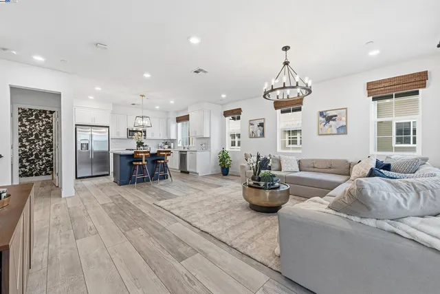 a living room with furniture and kitchen view