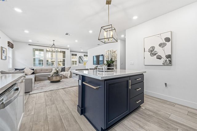 a kitchen with a sink appliances and a wooden floor