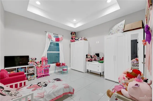 a bedroom with furniture and a flat screen tv