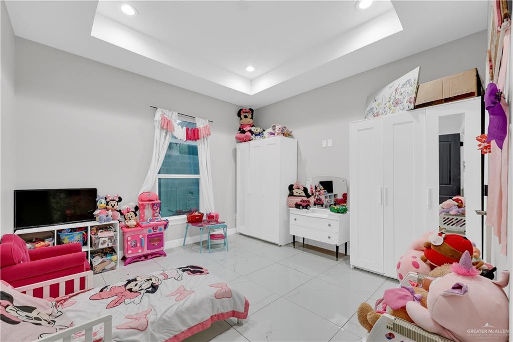 522 La Pointe Avenue Alton, TX 78573 - Photo 12 of 25 a bedroom with furniture and a flat screen tv