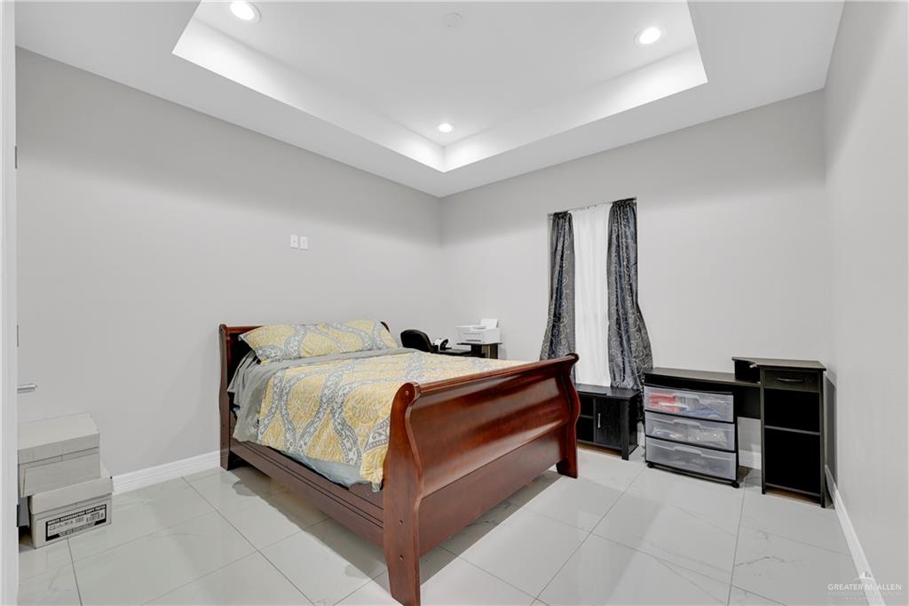 522 La Pointe Avenue Alton, TX 78573 - Photo 14 of 25 a bed room with a bed and a desk