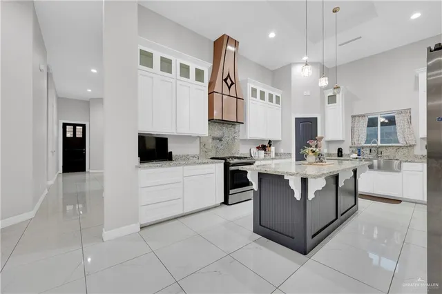 a kitchen with stainless steel appliances kitchen island granite countertop a sink and cabinets