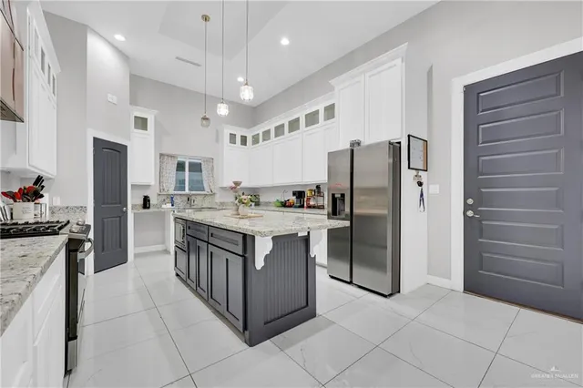 a kitchen with stainless steel appliances a refrigerator sink and cabinets