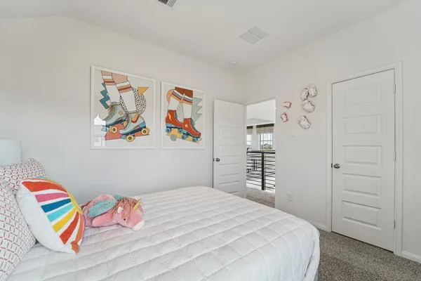 a bedroom with a bed and painting on the wall