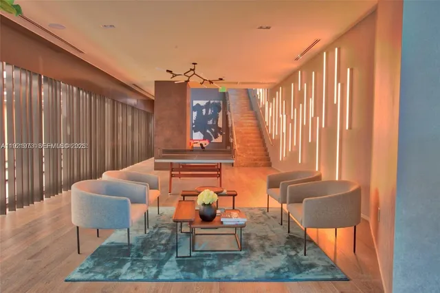 a balcony with chairs and a rug