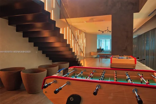 a view of gym equipment and stairs