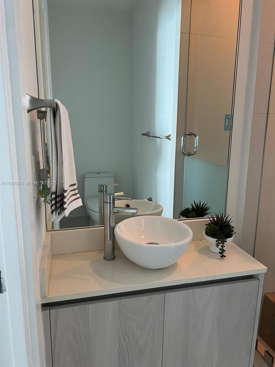 480 Northeast 31st Street, Unit 804 Miami, FL 33137 - Photo 21 of 39 a bathroom with a sink and a mirror