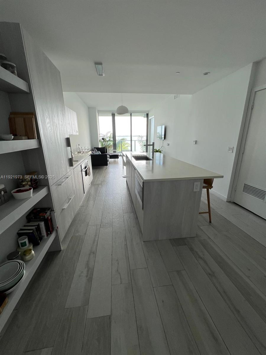 480 Northeast 31st Street, Unit 804 Miami, FL 33137 - Photo 23 of 39 a living room with furniture and a wooden floor