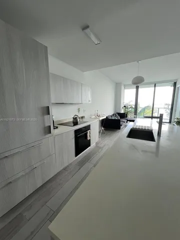 a kitchen with sink refrigerator and window