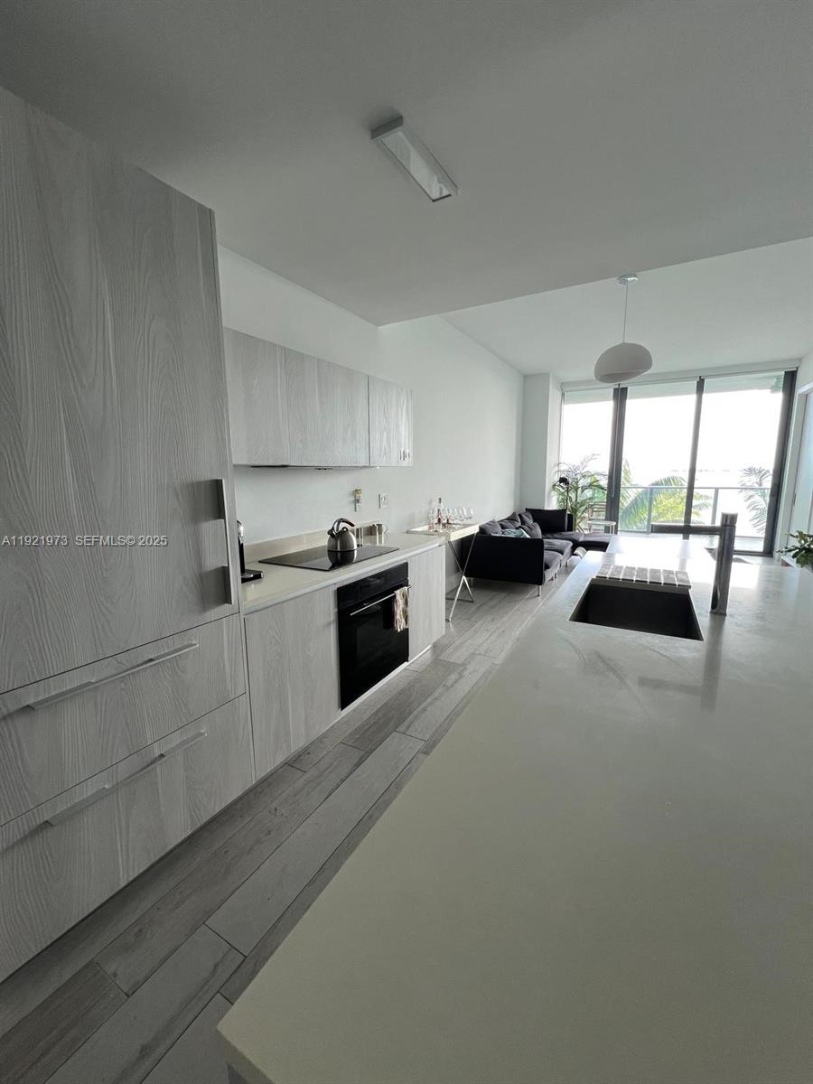 480 Northeast 31st Street, Unit 804 Miami, FL 33137 - Photo 24 of 39 a kitchen with sink refrigerator and window