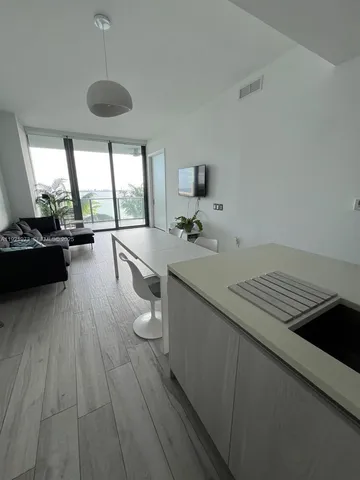 a open kitchen with a sink stove and wooden floor
