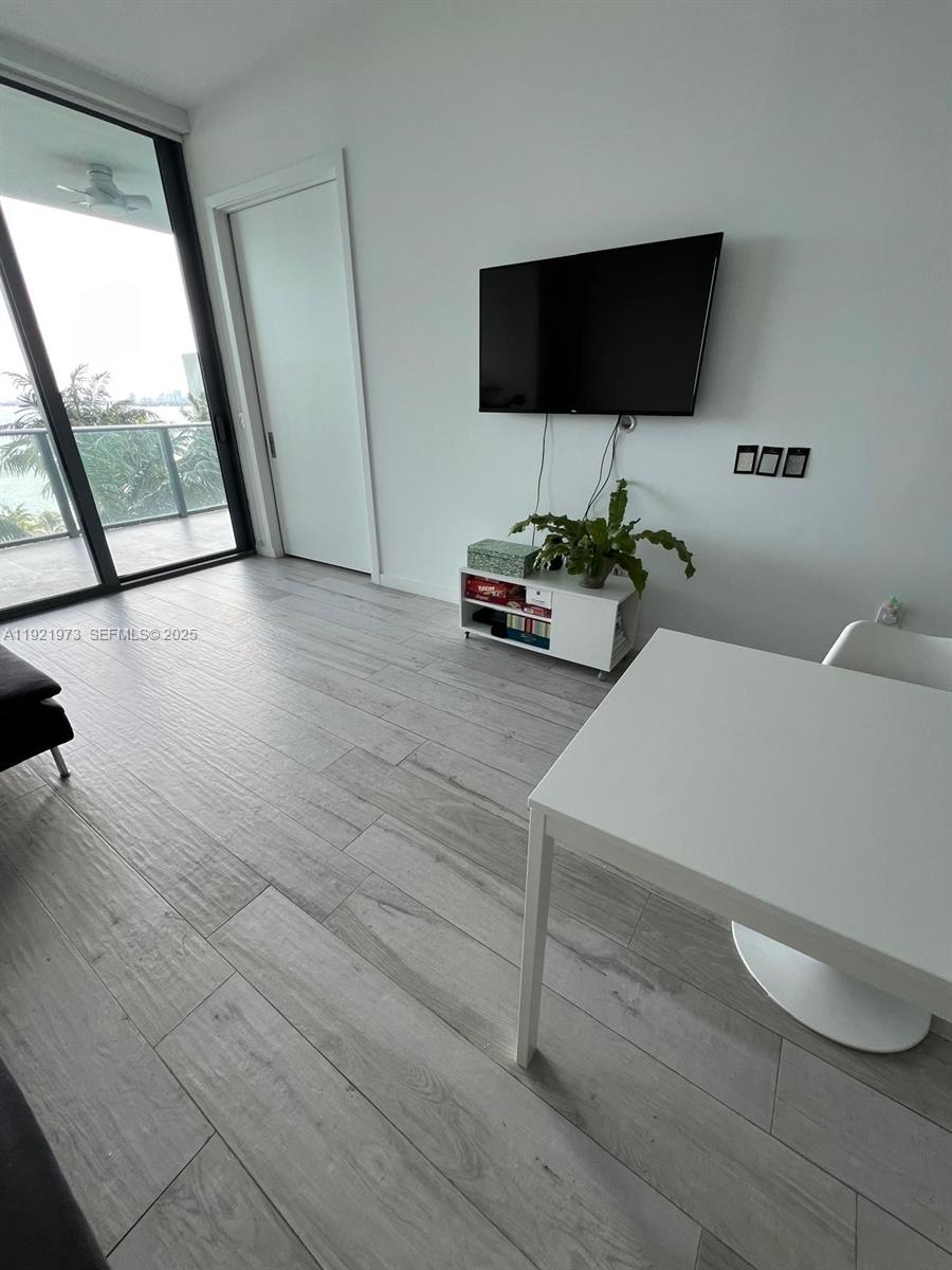 480 Northeast 31st Street, Unit 804 Miami, FL 33137 - Photo 27 of 39 a living room with furniture and a flat screen tv