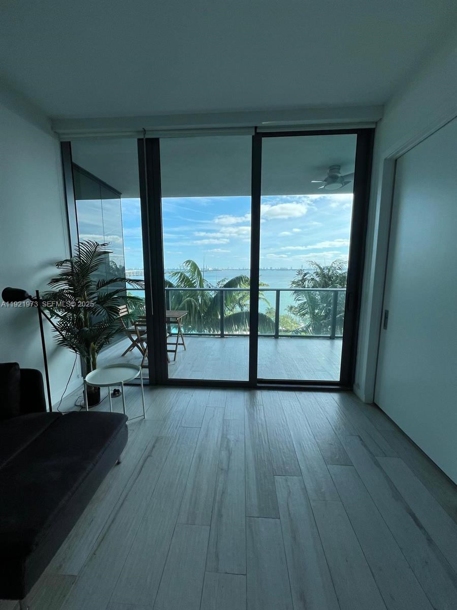 480 Northeast 31st Street, Unit 804 Miami, FL 33137 - Photo 28 of 39 a view of a room with wooden floor and a chair
