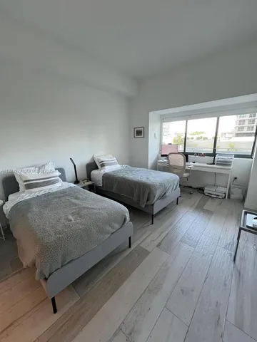 a bedroom with a bed and a table