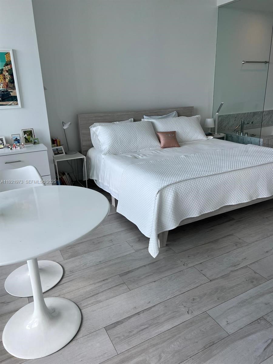 480 Northeast 31st Street, Unit 804 Miami, FL 33137 - Photo 36 of 39 a bedroom with a bed and a table