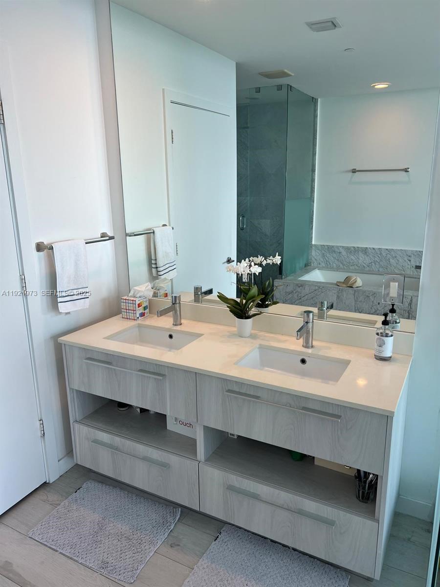 480 Northeast 31st Street, Unit 804 Miami, FL 33137 - Photo 37 of 39 a bathroom with a sink and a mirror