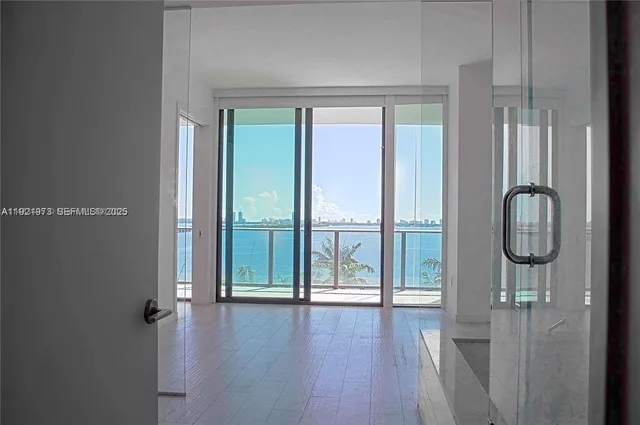 a view of a room with wooden floor and windows