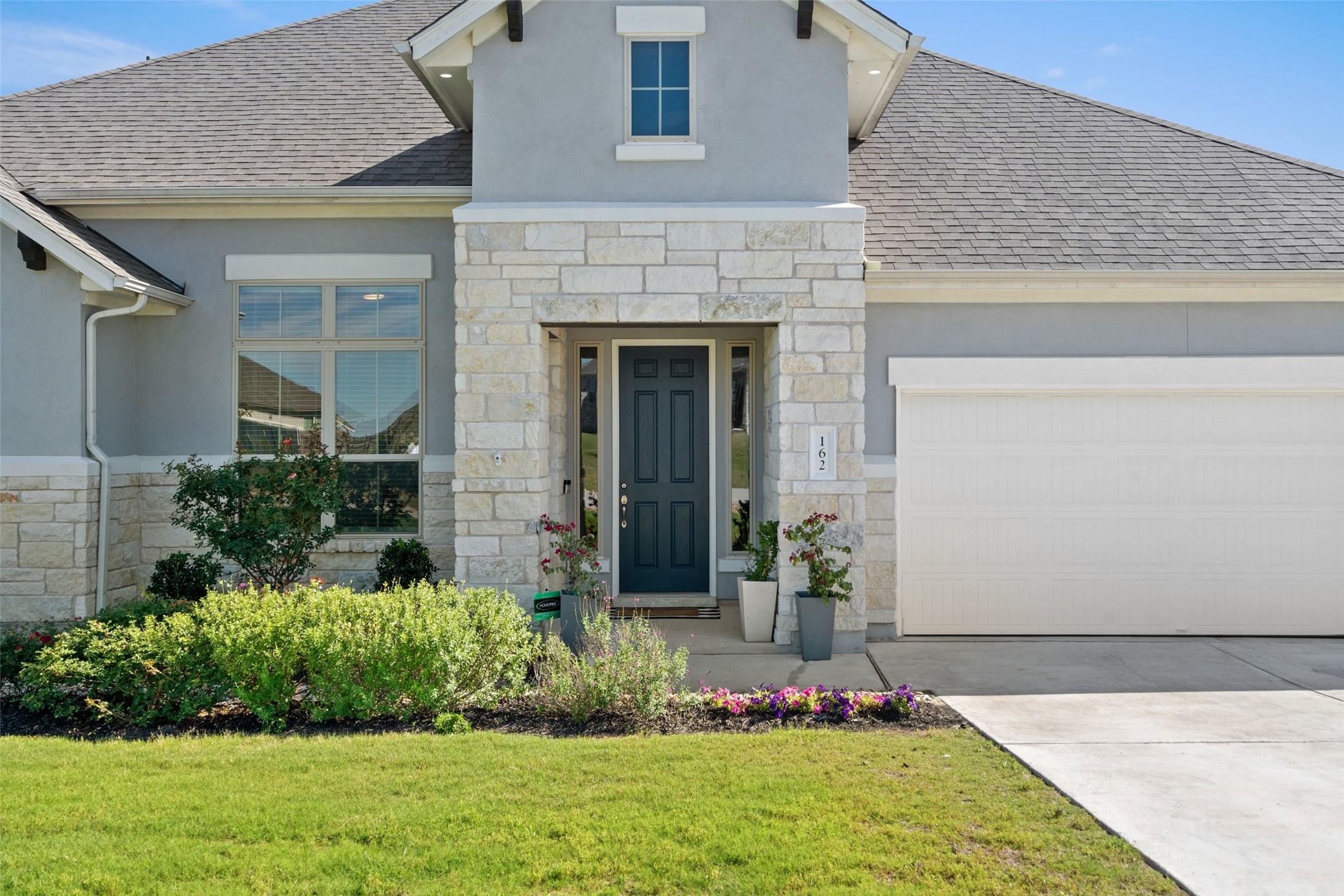 162 Lunar Loop Austin, TX 78737 - Photo 5 of 40 a front view of a house with a yard