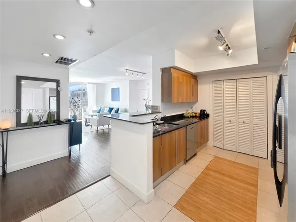 a large white kitchen with a large window