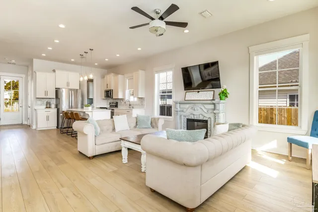 a living room with fireplace furniture and a flat screen tv