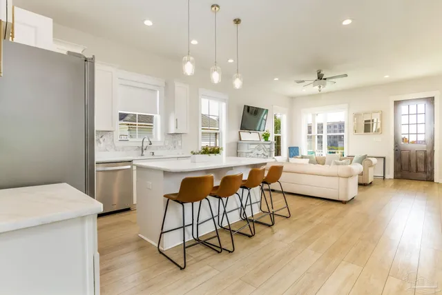 a living room with kitchen island furniture and a wooden floor