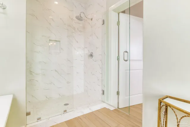 a bathroom with a glass shower door