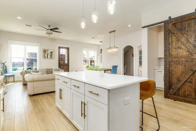 a large white kitchen with a large window