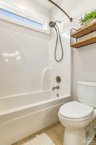 a bathroom with a toilet and a bathtub