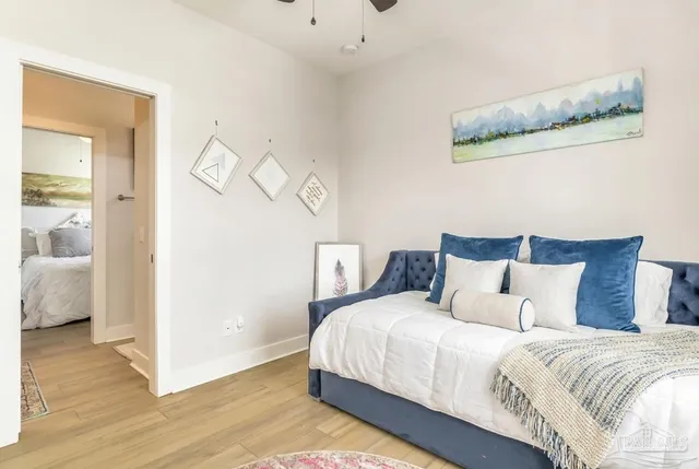 a bedroom with bed and wooden floor