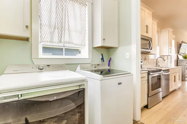 a view of a kitchen with stove and cabinets
