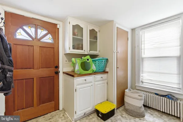 a bathroom with a sink a toilet and a window