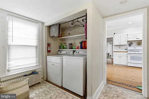a kitchen with a refrigerator and white cabinets