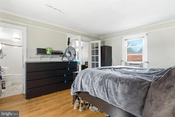 a bedroom with a bed and a dresser