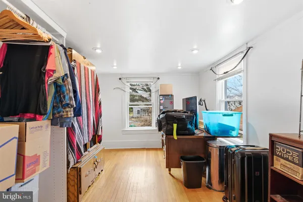 a view of a living room with clothes and shoes