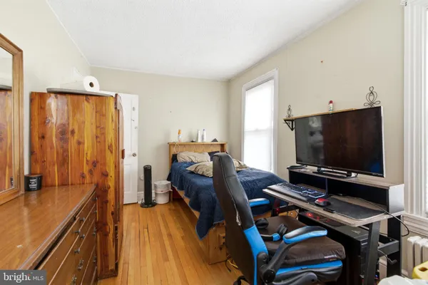 a bedroom with furniture and a flat screen tv